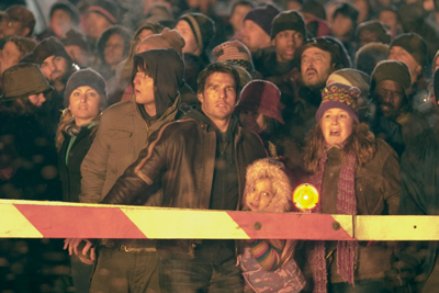 Tom Cruise and Dakota Fanning watch a burning train race past them